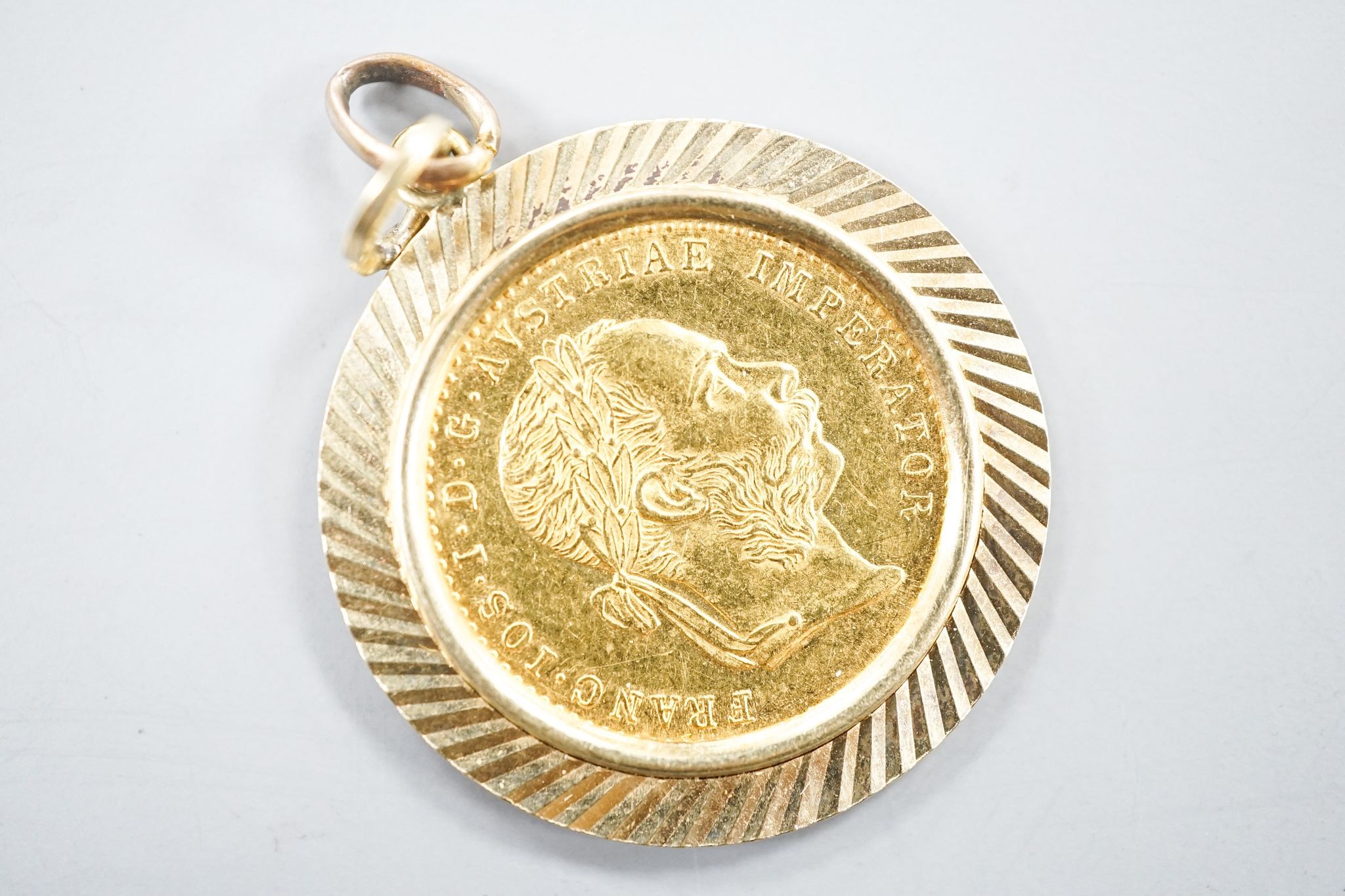 An Austrian 1915 gold ducat re-strike?, in a yellow metal pendant mount, gross weight 6 grams.